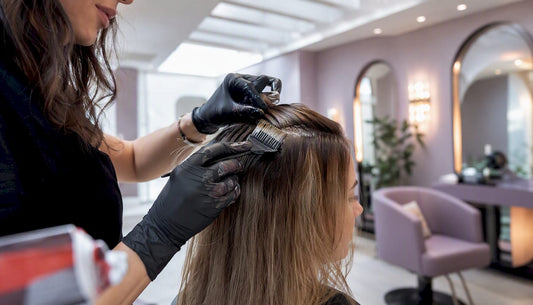 Stylist applying permanent hair colour close-up