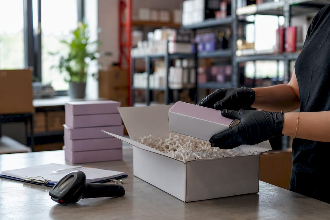 Hands packing salon supply boxes