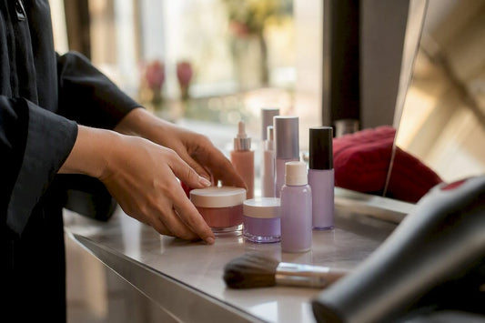 Hands arranging cosmetics and tools on salon station